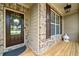 Warm and welcoming front door area with a decorated door, brick accents, and a cozy, covered porch at 432 Providence Walk St, Canton, GA 30114