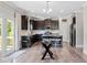 Stylish kitchen featuring dark cabinets, stainless steel appliances, an island, and modern fixtures at 432 Providence Walk St, Canton, GA 30114