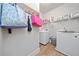 Efficient laundry room equipped with a washer, dryer, storage shelves, and stylish decor at 432 Providence Walk St, Canton, GA 30114