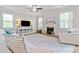 Bright living room featuring a fireplace, stylish rug, ceiling fan, and comfortable, neutral-toned furniture at 432 Providence Walk St, Canton, GA 30114