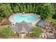 Aerial view shows a heart-shaped community pool surrounded by many lounge chairs and shaded seating at 432 Providence Walk St, Canton, GA 30114