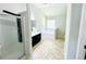 Bathroom showcasing glass shower, dark cabinets, tub, and modern fixtures at 4417 Belcamp Rd, Fairburn, GA 30213