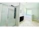Bright bathroom featuring glass shower, dark cabinets, and large soaking tub at 4417 Belcamp Rd, Fairburn, GA 30213