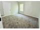 Comfortable bedroom with plush carpet, neutral walls, and natural light at 4417 Belcamp Rd, Fairburn, GA 30213