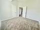 Neutral bedroom featuring plush carpet, light walls, and bright natural light at 4417 Belcamp Rd, Fairburn, GA 30213