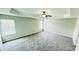 Comfortable bedroom featuring a ceiling fan, bright natural light, and plush carpet at 4417 Belcamp Rd, Fairburn, GA 30213