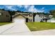 Two-story home with green siding, two-car garage, and a well-manicured lawn and landscape at 4417 Belcamp Rd, Fairburn, GA 30213