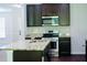 Kitchen with stainless steel appliances, granite countertops, and dark brown cabinets at 4417 Belcamp Rd, Fairburn, GA 30213