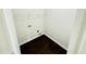 Laundry room with overhead wire rack and dark hardwood floors at 4417 Belcamp Rd, Fairburn, GA 30213