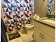 Modern bathroom with updated vanity, toilet, and geometrically-patterned shower curtain at 2433 Robin Ridge Dr, Dacula, GA 30019