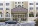 Exterior view of Park Lane entry, showcasing modern architectural design, glass facade, and parking at 2479 Peachtree Ne Rd # 301, Atlanta, GA 30305