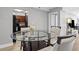 Bright dining area showcasing a glass-top table with seating, adjacent to a modern kitchen at 2479 Peachtree Ne Rd # 301, Atlanta, GA 30305