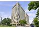 View of tall condo building with many windows and landscaping around the exterior at 2479 Peachtree Ne Rd # 301, Atlanta, GA 30305