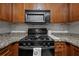 Kitchen showcasing granite counters, backsplash, dark cabinetry, and modern black appliances at 2479 Peachtree Ne Rd # 301, Atlanta, GA 30305