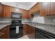Cozy kitchen featuring updated cabinetry, modern appliances, and granite countertops at 2479 Peachtree Ne Rd # 301, Atlanta, GA 30305