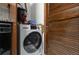 A laundry room features a modern washer/dryer with custom, wood-paneled door at 2479 Peachtree Ne Rd # 301, Atlanta, GA 30305