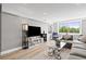 View of living room with hardwood floors, a stylish gray sectional sofa, and a scenic window view at 2479 Peachtree Ne Rd # 301, Atlanta, GA 30305