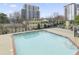 Community pool with stairs and an adjacent view of the buildings in the area at 2479 Peachtree Ne Rd # 301, Atlanta, GA 30305