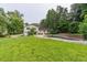 Expansive backyard featuring a generous lawn, a swimming pool, and mature trees at 4408 Shiloh Trl, Powder Springs, GA 30127