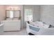 Bright bathroom showcasing a white vanity, large soaking tub, and elegant tilework at 4408 Shiloh Trl, Powder Springs, GA 30127