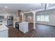 Modern kitchen with stainless steel appliances, white cabinets, and an island with cooktop at 4408 Shiloh Trl, Powder Springs, GA 30127