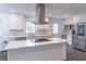 Well-lit kitchen features a center island, stainless steel appliances, and white cabinets at 4408 Shiloh Trl, Powder Springs, GA 30127