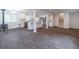 Spacious living room boasts wood-look floors, modern kitchen, and staircase access at 4408 Shiloh Trl, Powder Springs, GA 30127