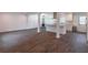 Open-concept living area with wood-look floors and a modern kitchen featuring a center island at 4408 Shiloh Trl, Powder Springs, GA 30127