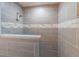 The shower features gray tiling with decorative horizontal accents and a built-in shelf at 4408 Shiloh Trl, Powder Springs, GA 30127