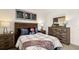 Bedroom featuring a wood-style dresser, plaid comforter, and sports themed artwork at 1622 Palladian Way, Lithonia, GA 30058