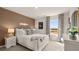 A bedroom featuring a stylish brown accent wall, white furniture, and a window with natural light at 1622 Palladian Way, Lithonia, GA 30058
