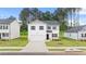 Charming two-story home featuring a two-car garage and beautifully maintained landscaping at 1622 Palladian Way, Lithonia, GA 30058