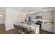 A stylish kitchen features granite countertops, stainless steel appliances, an island with seating, and ample cabinet space at 1622 Palladian Way, Lithonia, GA 30058