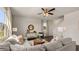 A spacious living room has an open layout, recessed lighting, lots of windows, and comfortable seating and decor at 1622 Palladian Way, Lithonia, GA 30058