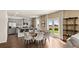 A combined kitchen and dining area offer an open floor plan, gray cabinets, stainless appliances, and a cozy living space at 1622 Palladian Way, Lithonia, GA 30058