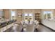 A dining area flows into a living area with a large window, open floor plan, and comfortable seating for relaxing at 1622 Palladian Way, Lithonia, GA 30058