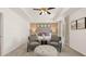 Neutral main bedroom with a tufted headboard, sitting area, and tray ceiling at 1622 Palladian Way, Lithonia, GA 30058