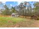Spacious backyard with a detached garage, fence, and grass at 195 Blackberry Run, Fayetteville, GA 30214