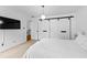 Clean bedroom with a modern light fixture, sleek sliding barn door, and plush bedding at 195 Blackberry Run, Fayetteville, GA 30214