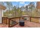 Wooden deck with a railing, an outdoor table and a view of a backyard at 195 Blackberry Run, Fayetteville, GA 30214