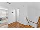 Upstairs hallway with hardwood floors, a doorway to a bedroom, and natural light at 195 Blackberry Run, Fayetteville, GA 30214