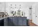 Stylish kitchen island with granite countertop, gas cooktop, and seating area at 195 Blackberry Run, Fayetteville, GA 30214