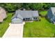 Aerial view of a well-maintained home with a green lawn and mature trees at 314 Spring Falls Drive, Lawrenceville, GA 30045