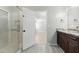 Well-lit bathroom with a glass shower, granite countertops, and wood-finished cabinets at 314 Spring Falls Drive, Lawrenceville, GA 30045