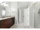 Bright bathroom featuring granite countertops, wood cabinets, and a glass-enclosed shower at 314 Spring Falls Drive, Lawrenceville, GA 30045