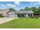 Charming single-story home with a well-maintained lawn and attached garage at 314 Spring Falls Drive, Lawrenceville, GA 30045