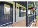 Close-up of the front porch featuring flower baskets and dark blue trim at 314 Spring Falls Drive, Lawrenceville, GA 30045