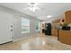 Bright kitchen featuring tile floors, ceiling fan, black appliances and light wood cabinetry at 314 Spring Falls Drive, Lawrenceville, GA 30045