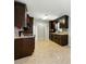 Galley kitchen with dark cabinets, stone countertops, and tiled backsplash at 314 Spring Falls Drive, Lawrenceville, GA 30045