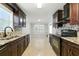 Well-lit kitchen featuring granite counters, dark wood cabinets and updated appliances at 314 Spring Falls Drive, Lawrenceville, GA 30045